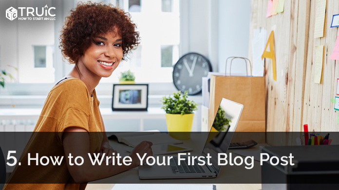 Woman writing her first blog post.
