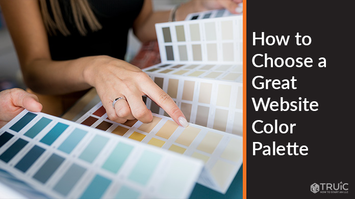 Person choosing colors from color swatches.