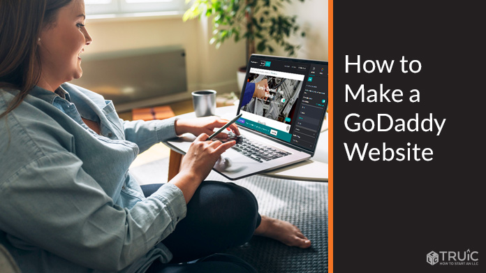 Woman making a GoDaddy website on a laptop.