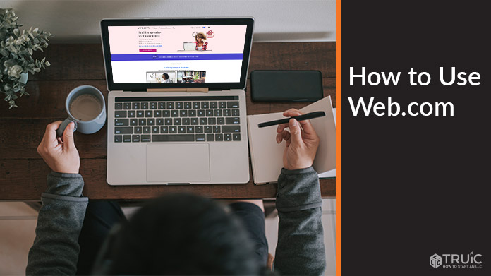 Person working on a computer with Web.com homepage on screen.