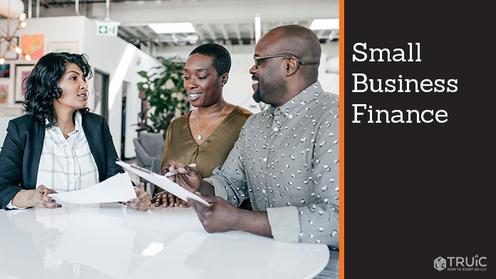 Couple with financial advisor going over financing for their small business.