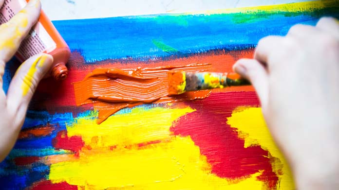 orange paint being added to a painting