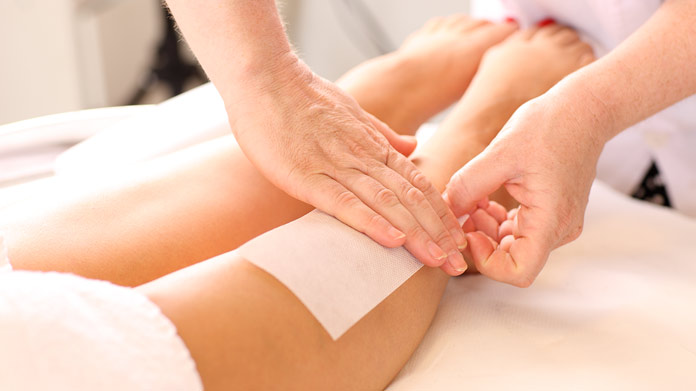 A person having their legs waxed