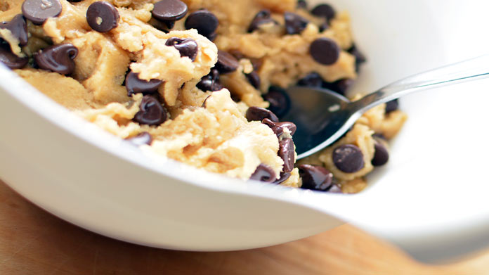 A spoon in a bowl of cookie dough
