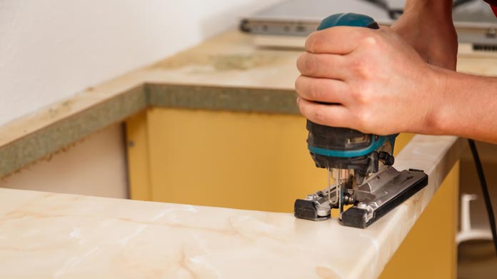 someone working on cutting a countertop