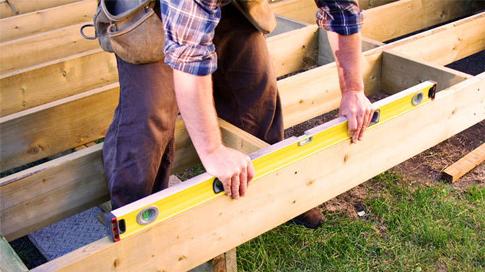 Person building a deck.
