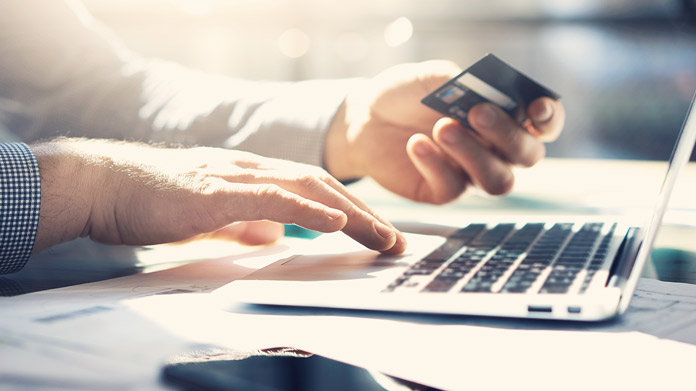 credit card info being input into a laptop