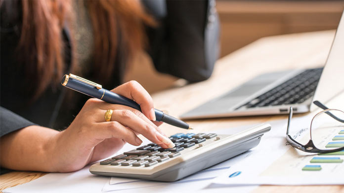 A businesswoman calculating funds