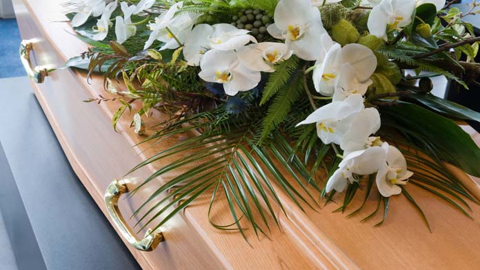 Casket with a flower blanket on top