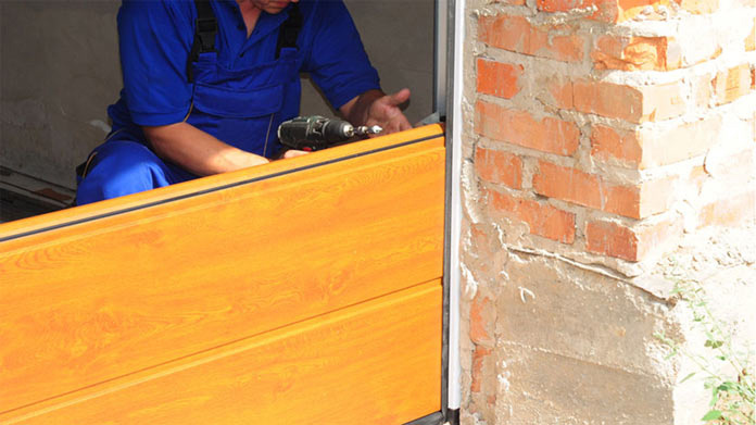 A person installing a garage door