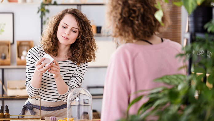 A lady showing a customer a health care product