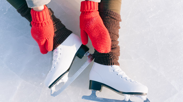 Someone putting on ice skates