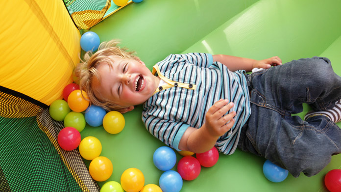 child playing in an inflatable bounce house