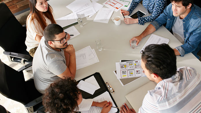 Business people conversing around a table