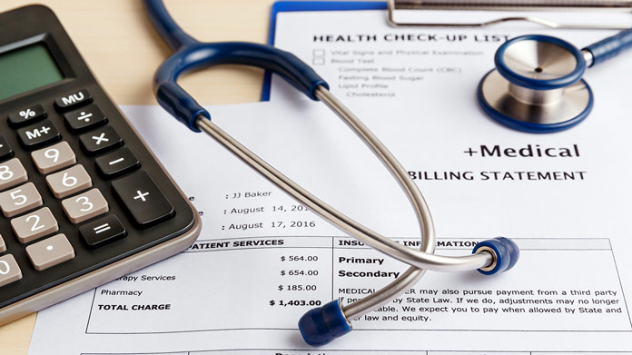 A medical billing statement with a stethoscope resting on it