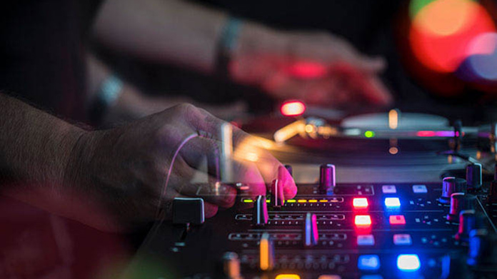 Person DJing on DJ equipment