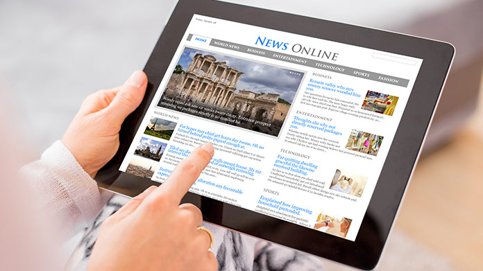 A tablet with a news website on its screen