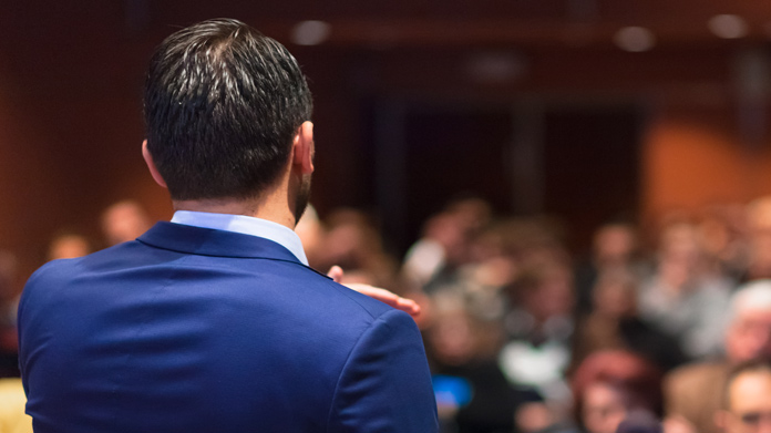 A person giving a speech in front of an audience