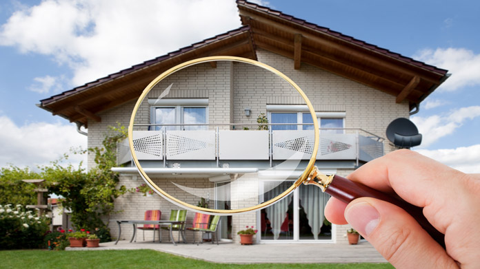 A magnifying glass held in front of a house