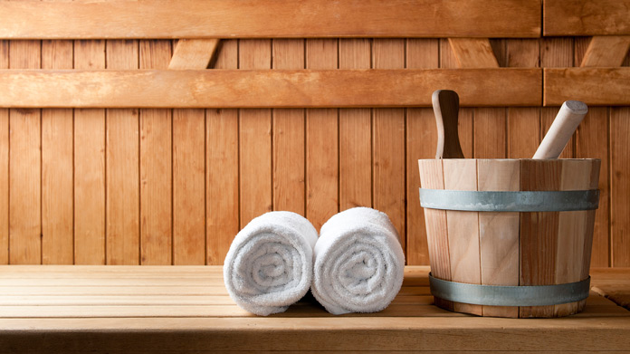 Two towels and a bucket in a sauna