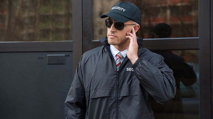 Security guard standing in front of a business