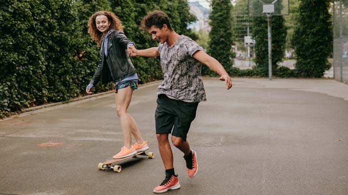 A person receiving skateboarding lessons