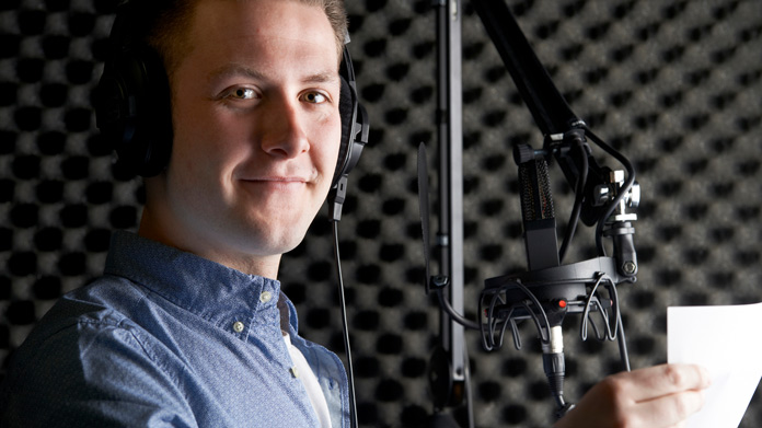 A voice actor in front of a microphone