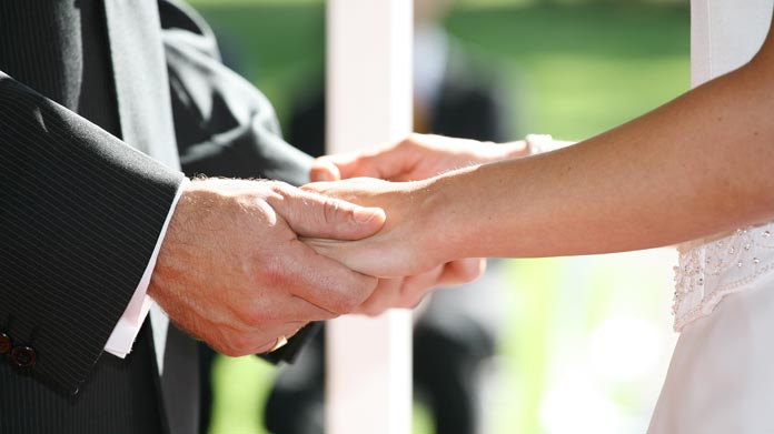 A bride and groom holding hands
