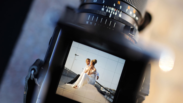 A bride and groom displayed in a camera viewfinder