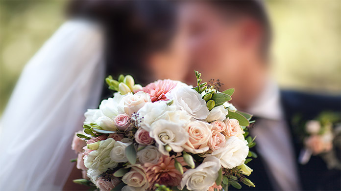 A couple kissing at their wedding