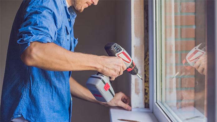 A person installing a window