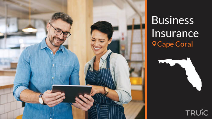 Two business owners looking at options for business insurance.