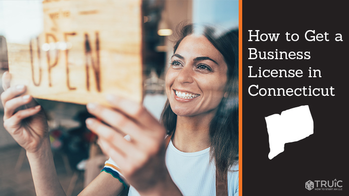 Woman holding open sign after getting her business license