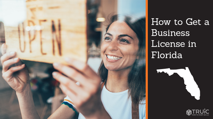 Woman holding open sign after getting her business license