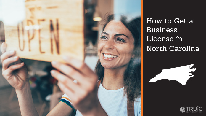 Woman holding open sign after getting her business license