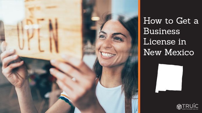 Woman holding open sign after getting her business license