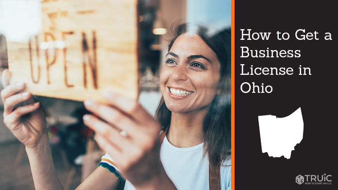 Woman holding open sign after getting her business license