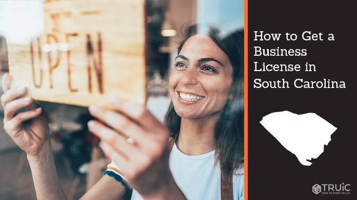 Woman holding open sign after getting her business license
