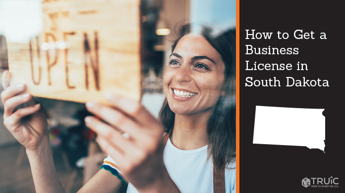 Woman holding open sign after getting her business license
