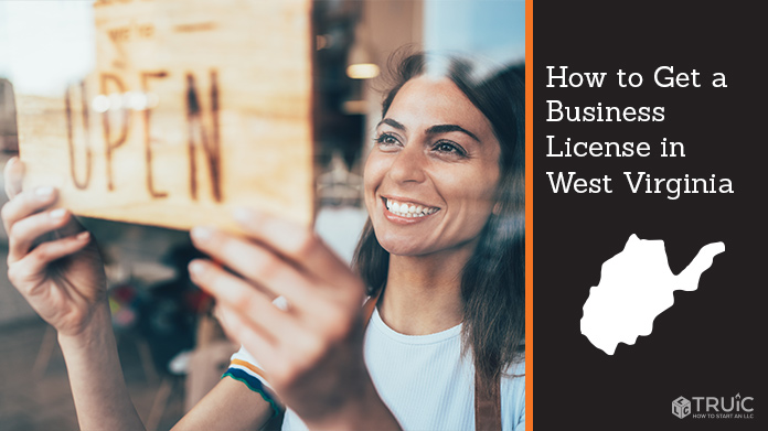 Woman holding open sign after getting her business license
