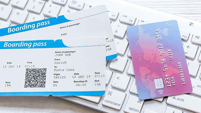 two boarding passes next to a credit card for airline miles