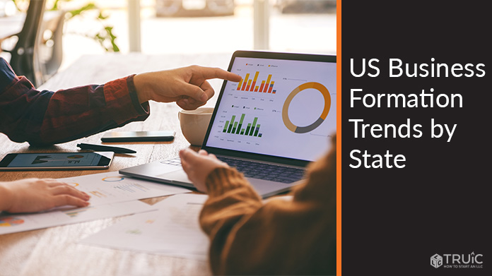 Two people looking at graphs and charts.