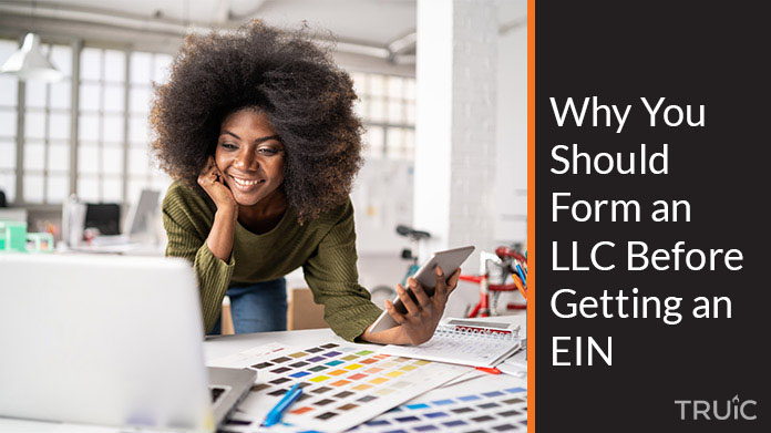 a woman looking at a computer realizing she should form her L L C before getting an E I N