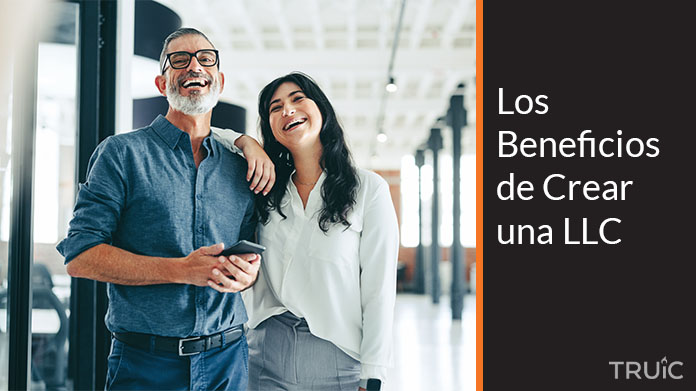 Dos emprendedores (una mujer y un hombre) chocando la mano celebrando en una oficina.