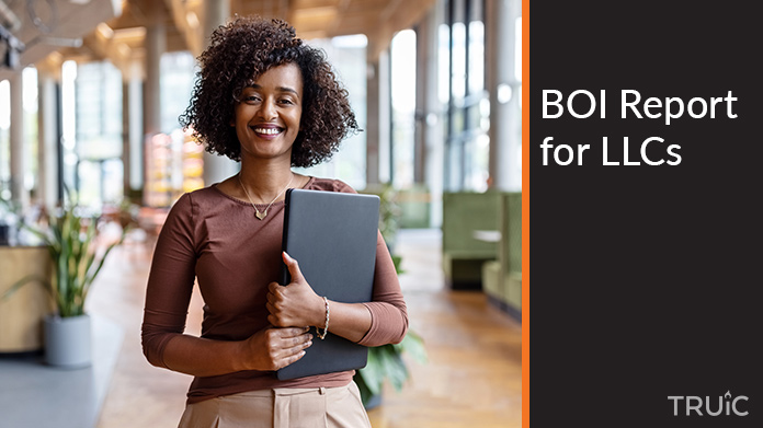 Woman holding a BOI Report for her LLC.