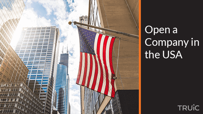 An industrial city at dusk overlaid with “open a company in the USA”