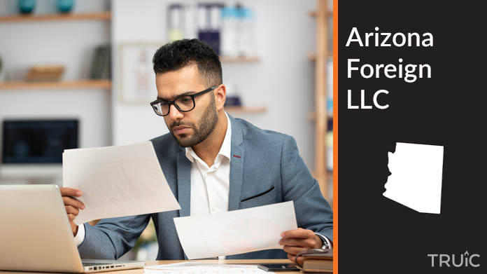 Man looking at paperwork to form his foreign LLC.