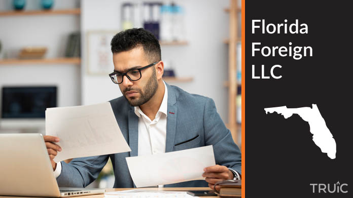 Man looking at paperwork to form his foreign LLC.