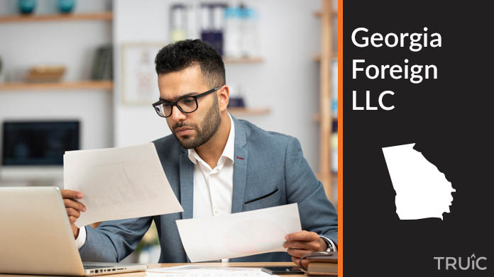 Man looking at paperwork to form his foreign LLC.