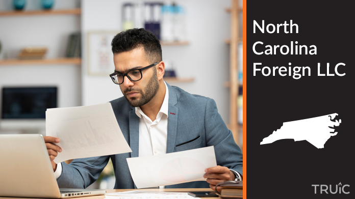 Man looking at paperwork to form his foreign LLC.